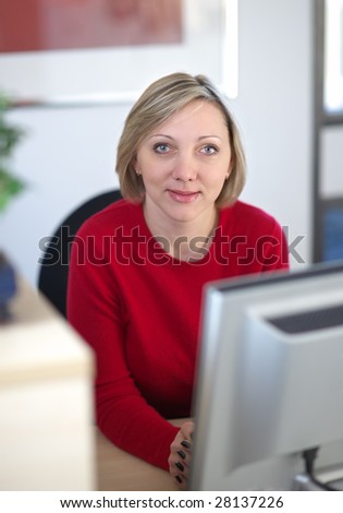 A shallow focus image of a female receptionist looking direct at the viewer