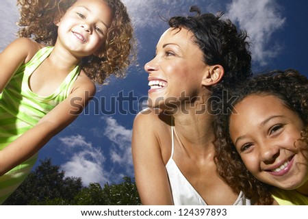 Mom and hers little girls smiling and having fun