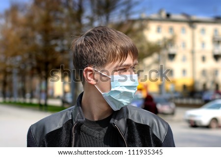 teenager in the flu mask on the street