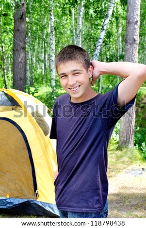 Happy young Man camping in the forest