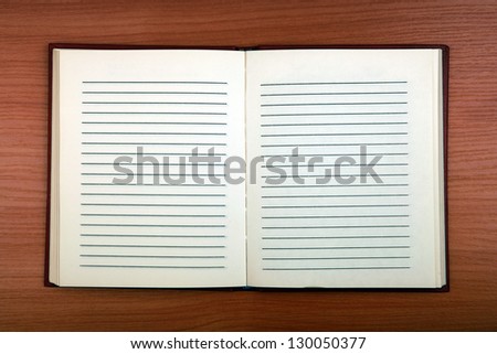 Blank Writing Pad on the Wooden Background