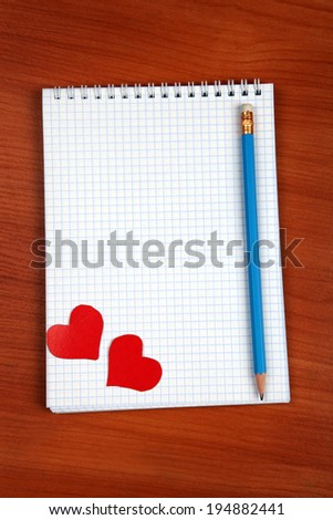 Blank Writing Pad with Heart Shapes and Pencil On The Table