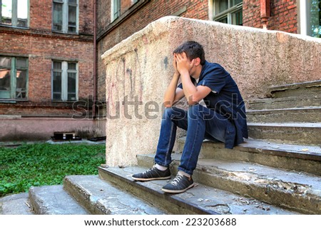 Sad Teenager on the landing steps of the Old House