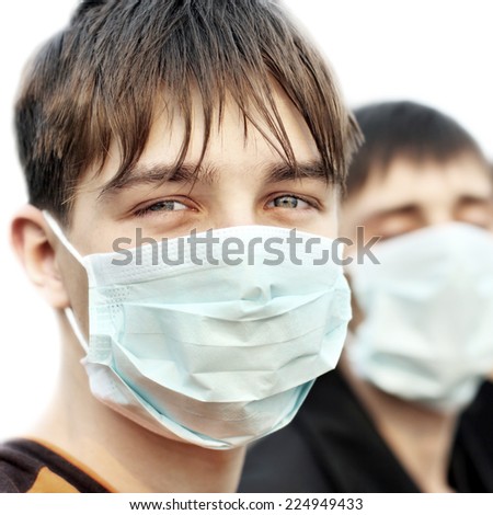 Two Teenagers in the Flu Mask on the White Background closeup