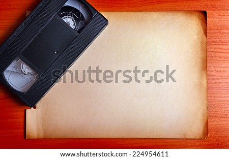 Retro Video Tape on the Board with the Empty Paper