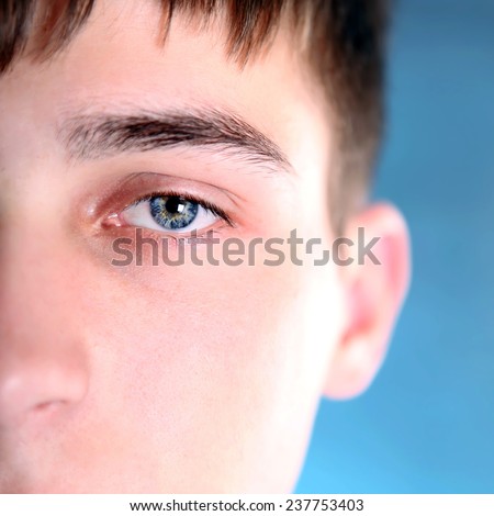 Part of Face of the Teenager with Focus on an Eye
