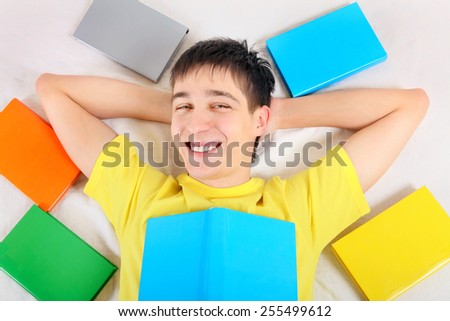 Happy Teenager with a Books on the Bed