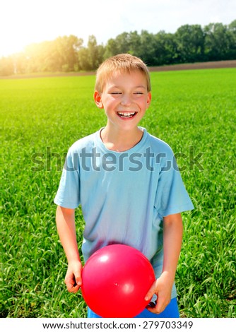 Kid with a ball in the summer field