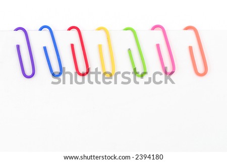 colorful  paper clip with whitepaper