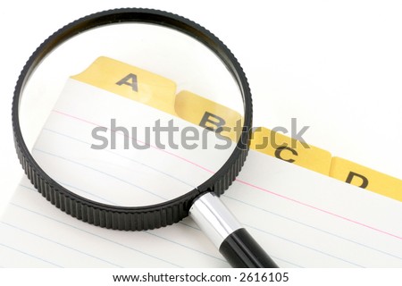 yellow file divider and magnifier, office supplies, close up