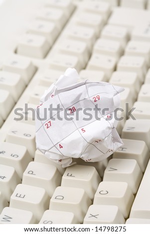 Calendar paper ball and computer keyboard, concept of time planning, Wasting Time, Unorganized