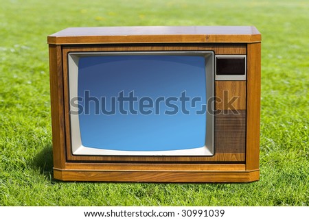 Old-fashioned Television and green grass