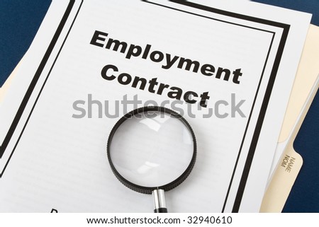 Employment Contract and magnifier, business concept