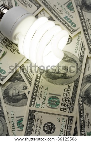 Compact Fluorescent Light bulb and dollar clsoe up