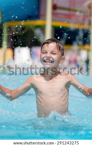 Happy boy, relaxing on a swimming pool at aqua park