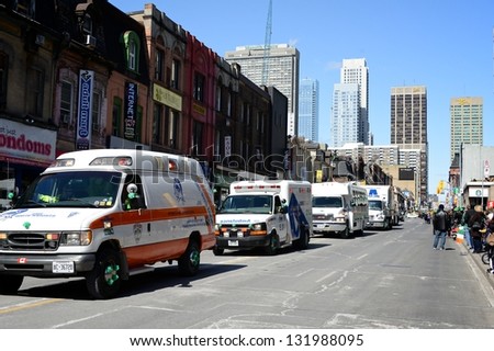 TORONTO - MARCH 17: Ambulance squad marches on the street. Toronto\'s annual St. Patrick\'s Day parade takes place under sunny skies on Sunday afternoon March 17, 2013.