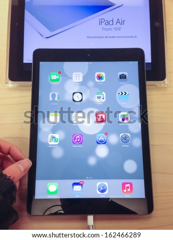 TORONTO - NOVEMBER 11: Custormer tries the iPad Air at the Apple Store in Toronto, Canada on November 11, 2013.