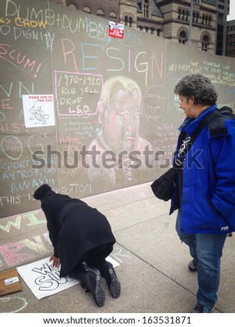 TORONTO - NOVEMBER 16: Protester against the mayor Rob Ford writes on the floor in Toronto, Canada on November 16, 2013.