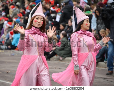 TORONTO - NOVEMBER 17: Girls disguised as   fairy tail characters attend 109th Toronto Santa Claus Parade in Toronto, Canada on November 17, 2013.