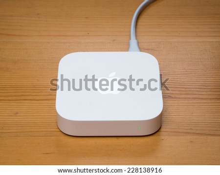 SHANGHAI, CHINA - MARCH 2014: An AirPort Express sits on the desk. The redesigned AirPort Express has been released by Apple in 2012.