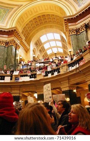 MADISON, WI - FEB 17: Thousands fill the capitol protesting Wisconsin Gov Scott Walker\'s proposal to eliminate collective bargaining rights for public workers on Feb 17, 2011 in Madison Wisconsin.