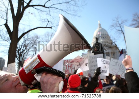 MADISON, WI-FEB 19: Opponents and supporters of Gov Scott Walker\'s bill to take away public worker bargaining rights chant slogans and carry signs on February 19, 2011 in Madison, Wisconsin.