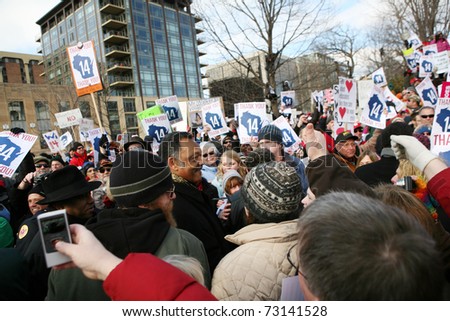 MADISON, WI - MAR 12: Crowds cheer for Rev Jackson at a rally on March 12, 2011 in Madison, Wisconsin. The rally was held to welcome back democrats who fled the state to prevent a vote on collective bargaining rights.