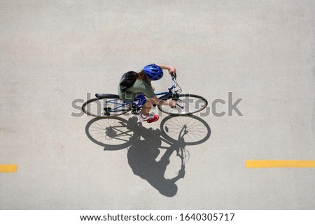 Similar – Image, Stock Photo shadow of cyclist on the side of bridge