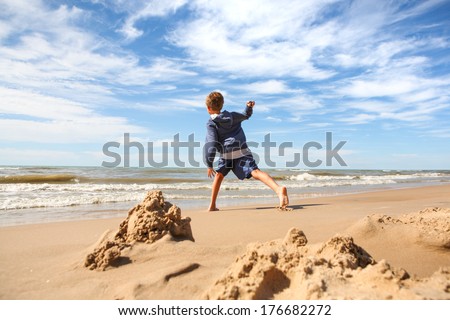 Boy throwing rocks into the lake