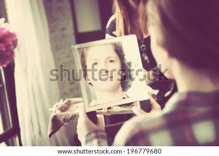 Bridesmaid looking in mirror after getting hair done
