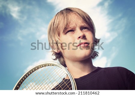 Adolescent boy with a tennis racket