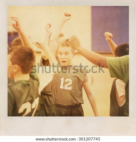 Young basketball player cheering with his team.  Vintage grunge