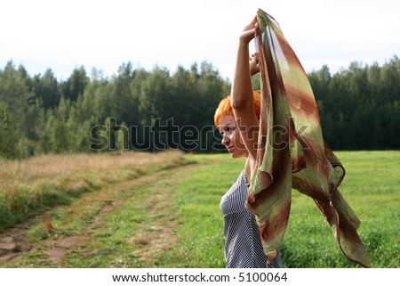 young woman with scarf in a field