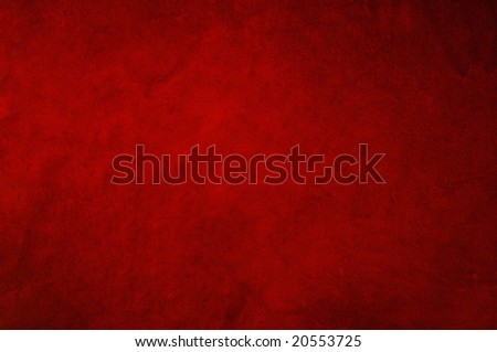 Dark red background fabric with soft folds and smudges in uneven candlelight.