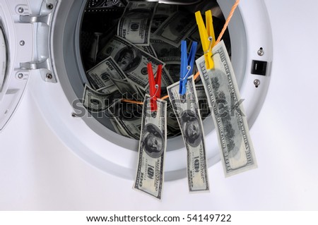 Money laundering concept - 100 dollar bills laundered in a washing machine.