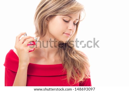 beautiful girl using perfume in red is bottle