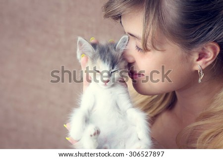 beautiful girl hugging a small kitten
