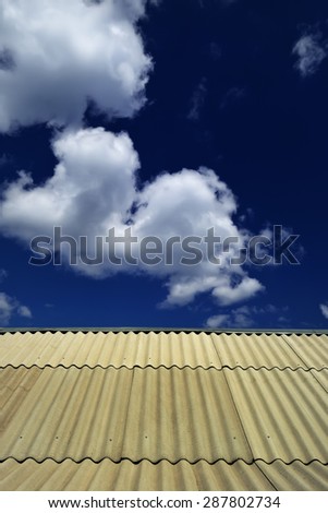 Summer landscape - the roof is covered with slate, aimed at a dark blue sky with clouds