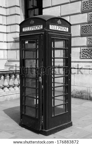 Traditional telephone booth in London, black and white photo