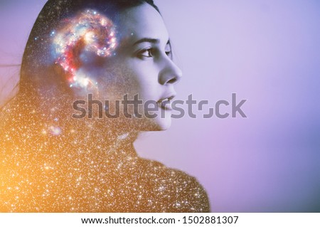 Double multiply exposure abstract portrait of a dreamer cute young woman face with galaxy universe space inside head. Spirit cosmos astronomy life zen concept Elements of this image furnished by NASA