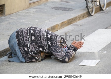 Florence - October 14: Unknown street beggar near Piazza del Duomo on Oct 26, 2014 in Florence, Italy. Due to the economic crisis in euro zone, job is hard to find.