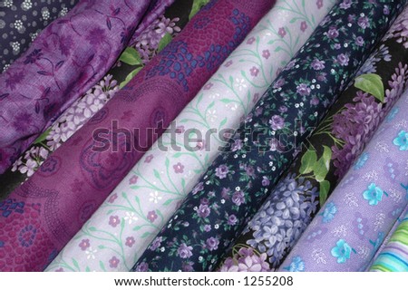 Bolts of quilt fabric in the purple and lavender range.