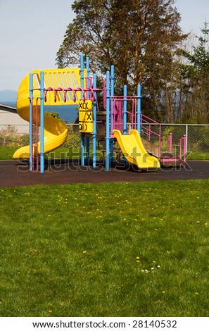 A colorful play set sits empty on a beautiful spring day.