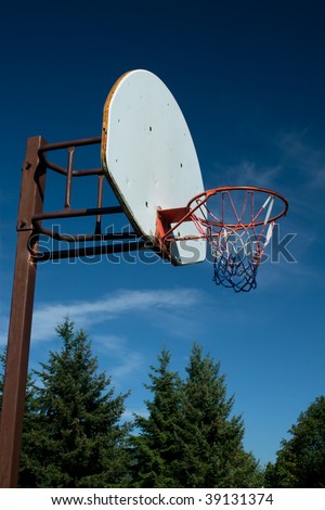 An American red-white-and-blue Basketball Hoop Against a Blue Sky