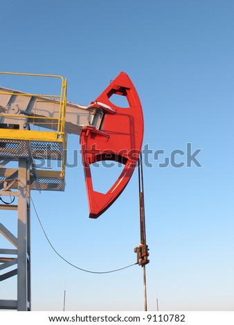 Oil pump jack in work. Oil industry in West Siberia. Siberian frost in sunny day.