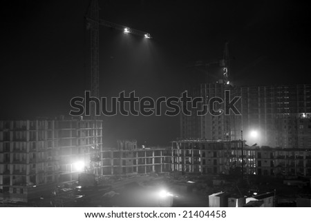 Night work on a building area . Black and white photo