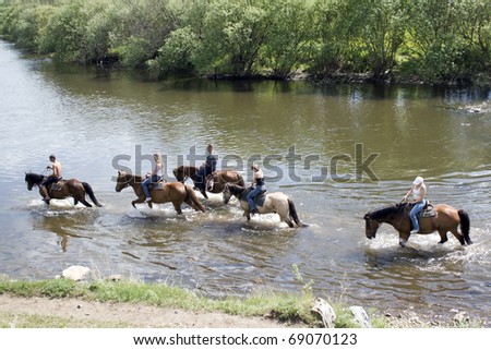 Russia - JUNE 6 : Group having a rest are forwarded through the river on horses  Event June 6, 2009 in Ufa, Russia. Open championship on tourism 2009  Horse riding on the mountain river