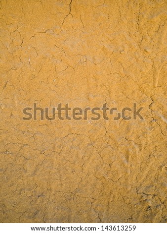 Background of crack clay wall, dark orange when weathered or heated.