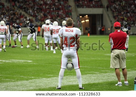 WARSAW, POLAND - SEPTEMBER 1: American football player, US team member Derek Vacha (K/P) watches the game at the field line during Euro-American Challenge match on September 1, 2012 in Warsaw, Poland.