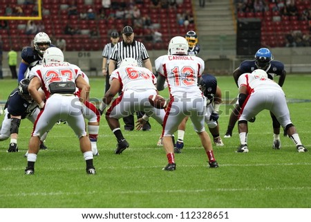 WARSAW, POLAND - SEPTEMBER 1: American football player, Europe team member Isaac Williams passes a football to Wes Carroll during Euro-American Challenge match on September 1, 2012 in Warsaw, Poland.